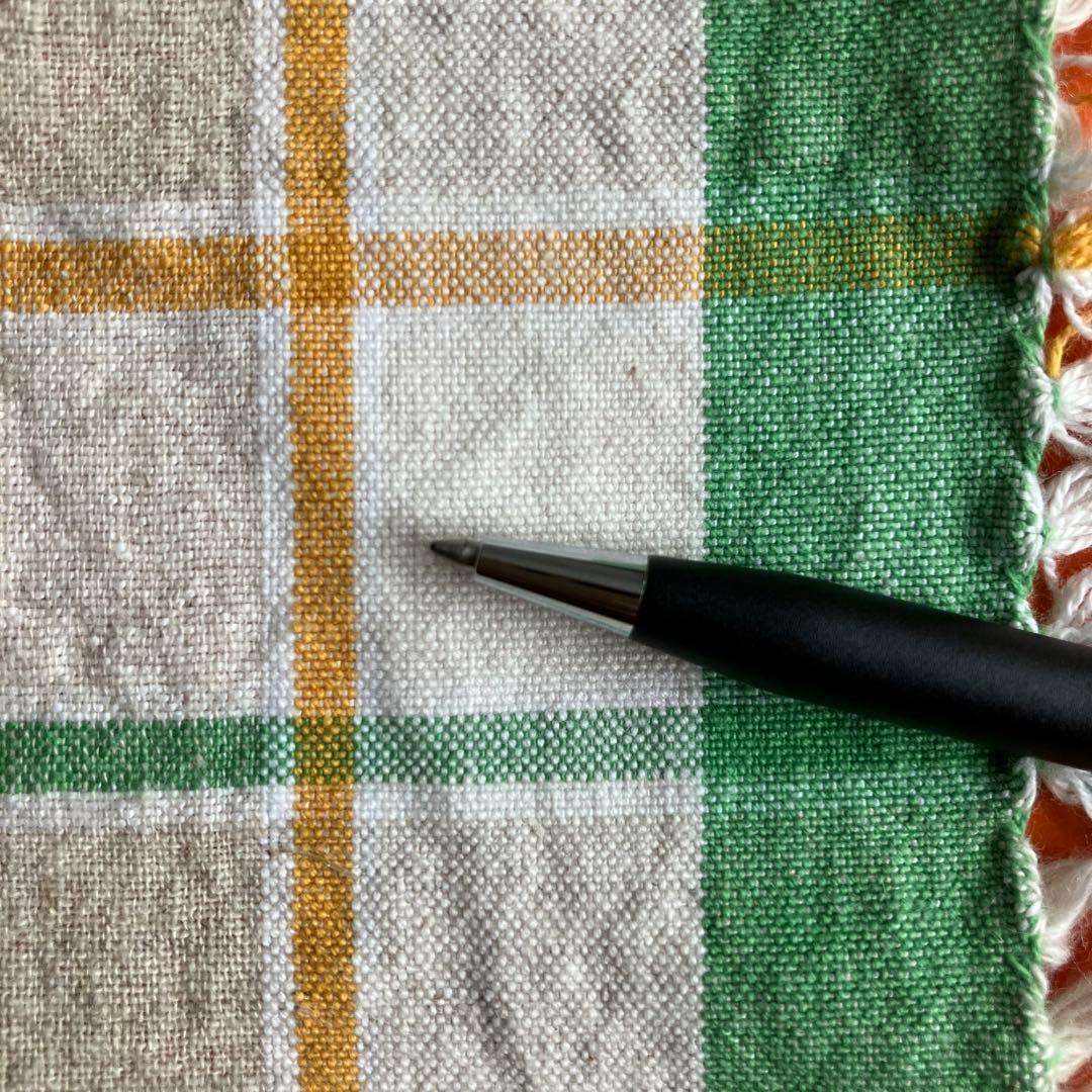Cross black matte ballpoint pen with silver accents next to Parker blue and black fountain pen with gold nib engraving 88