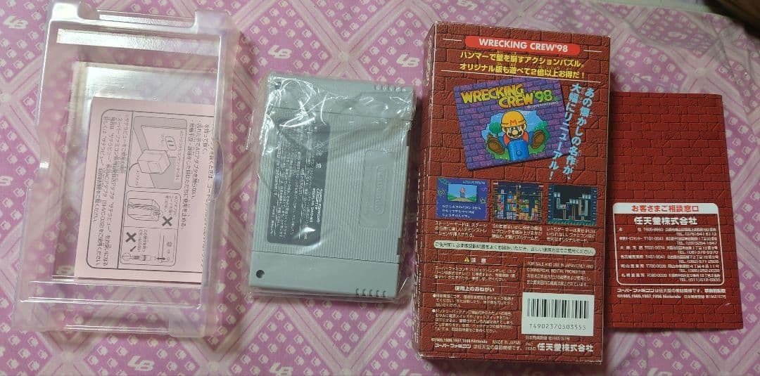 SNES Recking Crew 98 game cartridge with original box and manual showing slight wear on outer box