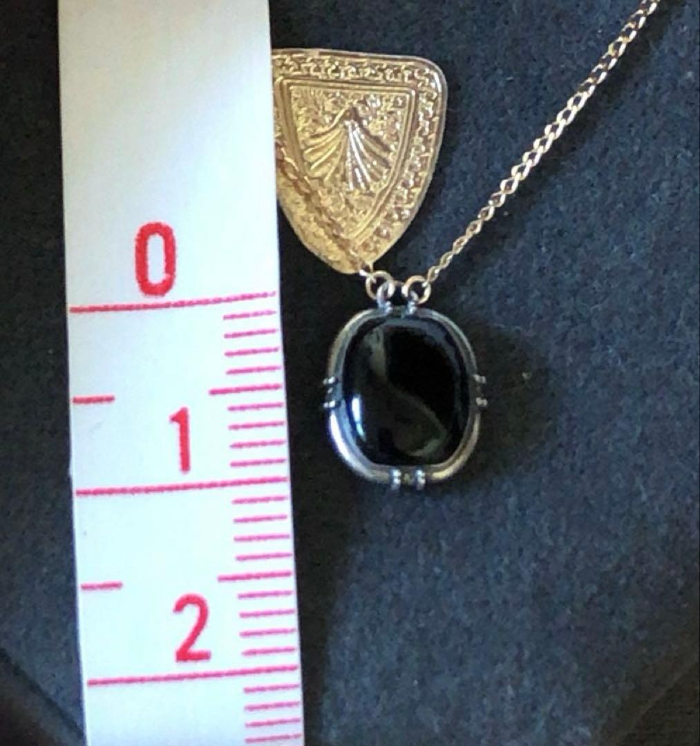 Agete K10 gold and silver necklace with small pendant and adjustable chain laid flat