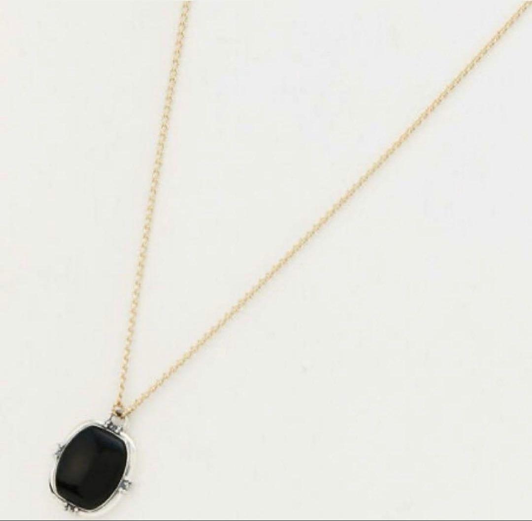 Agete K10 gold and silver necklace with small pendant and adjustable chain laid flat