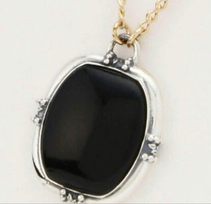 Agete K10 gold and silver necklace with small pendant and adjustable chain laid flat