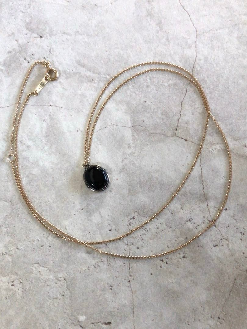 Agete K10 gold and silver necklace with small pendant and adjustable chain laid flat