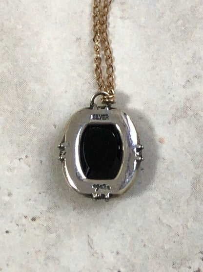 Agete K10 gold and silver necklace with small pendant and adjustable chain laid flat