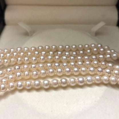 Long 125cm three-strand Akoya pearl necklace with 6.5mm pearls displayed on white background