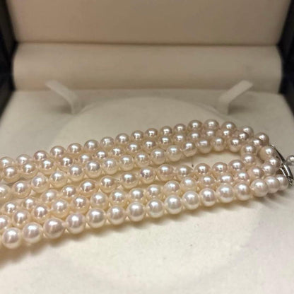 Long 125cm three-strand Akoya pearl necklace with 6.5mm pearls displayed on white background
