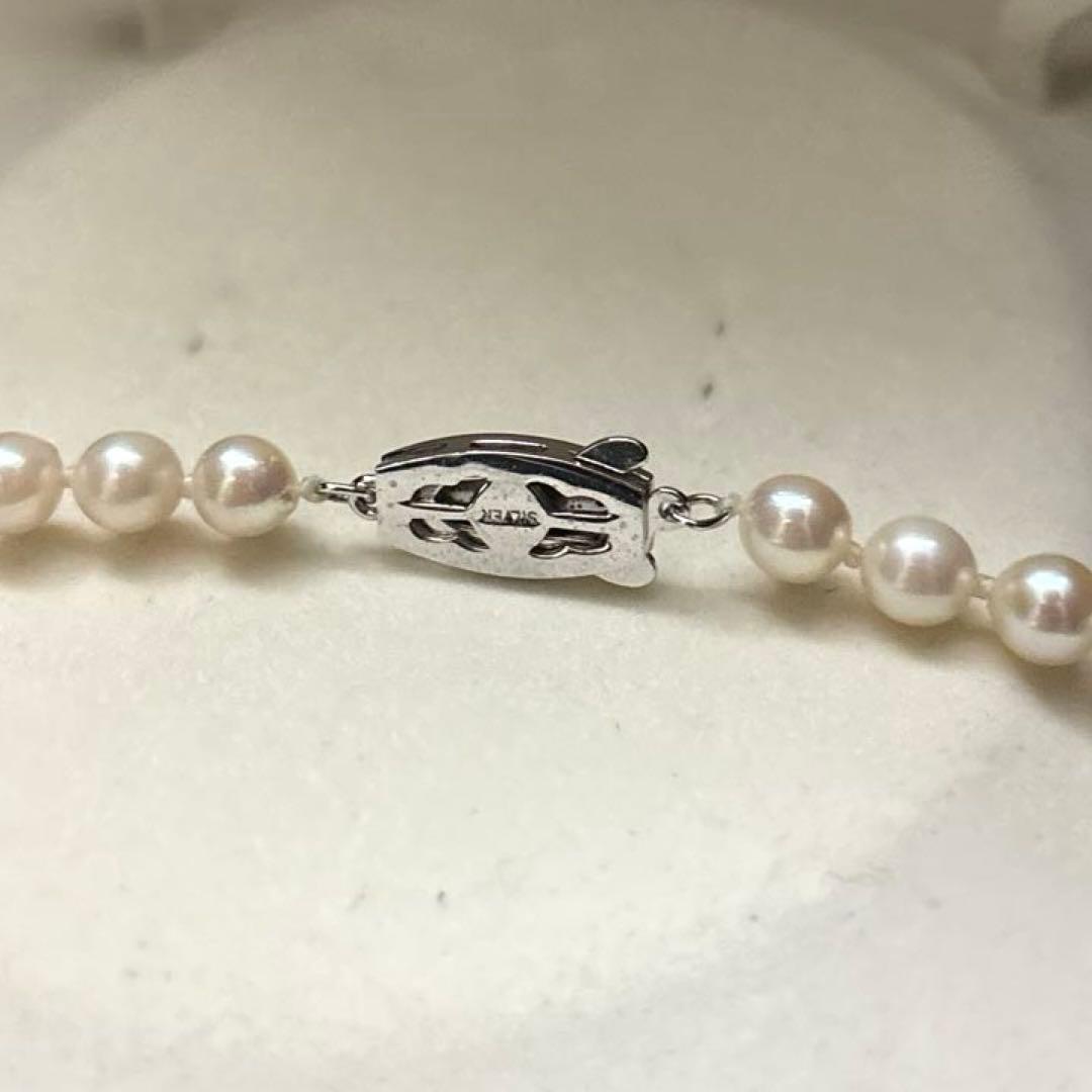 Long 125cm three-strand Akoya pearl necklace with 6.5mm pearls displayed on white background