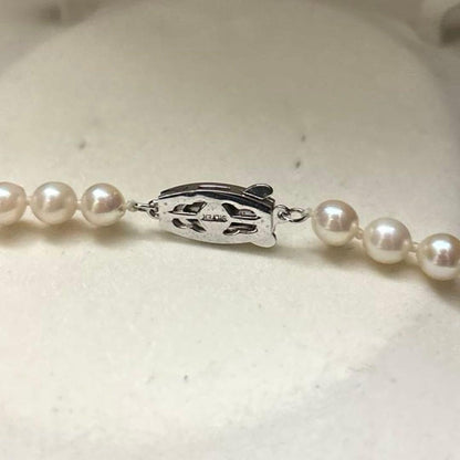 Long 125cm three-strand Akoya pearl necklace with 6.5mm pearls displayed on white background
