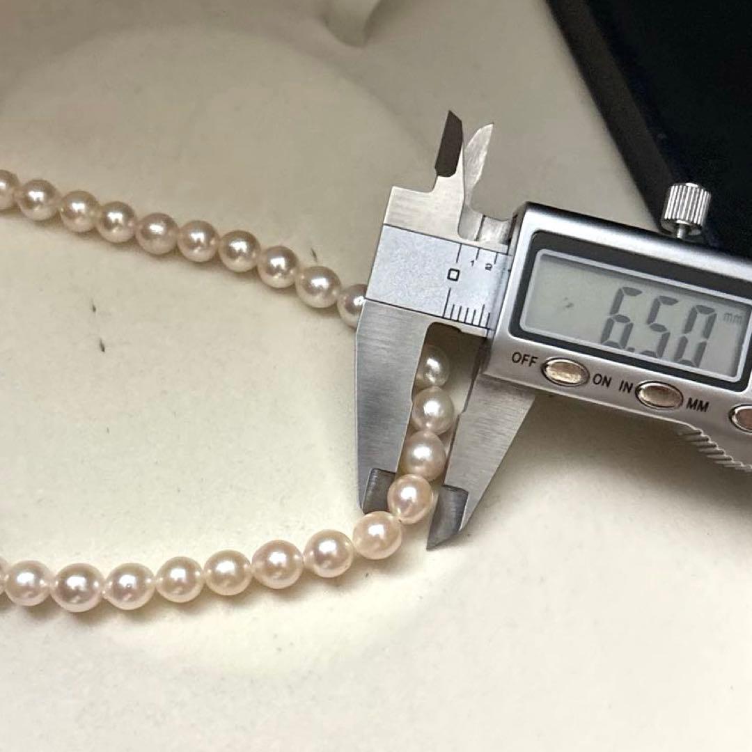 Long 125cm three-strand Akoya pearl necklace with 6.5mm pearls displayed on white background