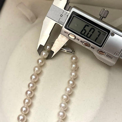 Long 125cm three-strand Akoya pearl necklace with 6.5mm pearls displayed on white background