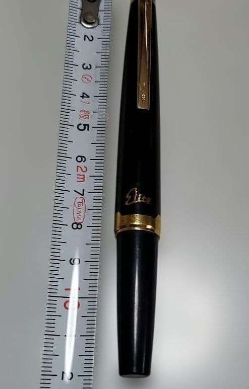 Black Pilot Elite fountain pen with resin body and gold plated accents shown with 14K586 nib
