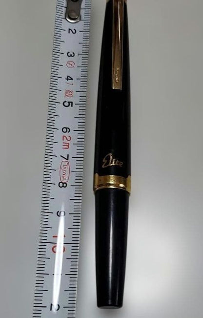 Black Pilot Elite fountain pen with resin body and gold plated accents shown with 14K586 nib