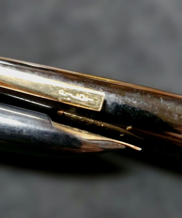 Black Pilot Elite fountain pen with resin body and gold plated accents shown with 14K586 nib