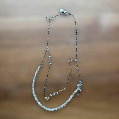 Agete Kuro necklace featuring white beads and metal double chain with slight scratches and discoloration