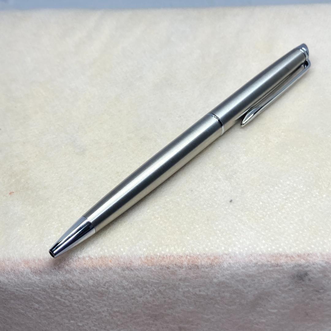 Waterman ballpoint pen with silver metal body, twist mechanism, black ink, and matching silver case