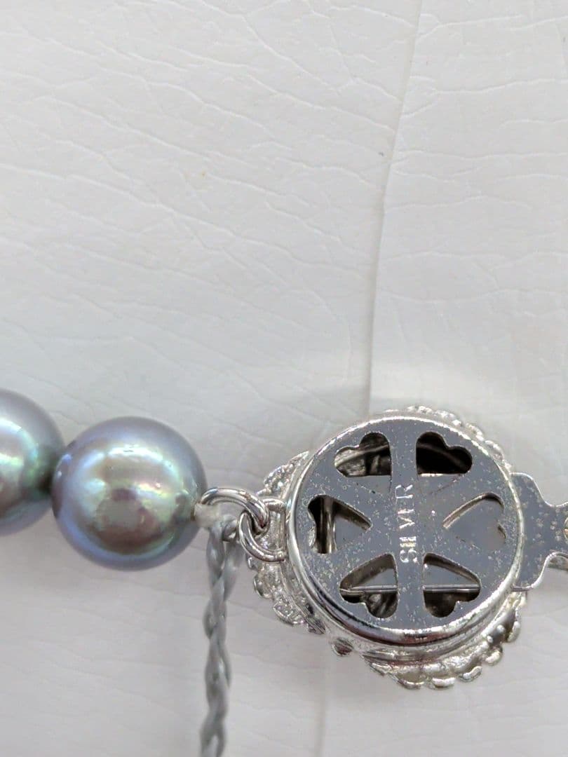 Akoya black pearl necklace featuring 7mm light peacock South Sea pearls with silver clasp, 42.3 cm length