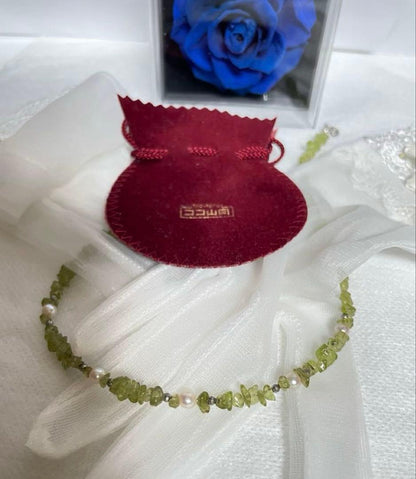 Pink Aurora Akoya Pearl necklace featuring 7 baby pearls and peridot stones with silver clasp