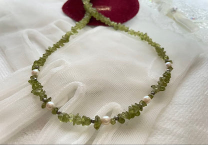 Pink Aurora Akoya Pearl necklace featuring 7 baby pearls and peridot stones with silver clasp