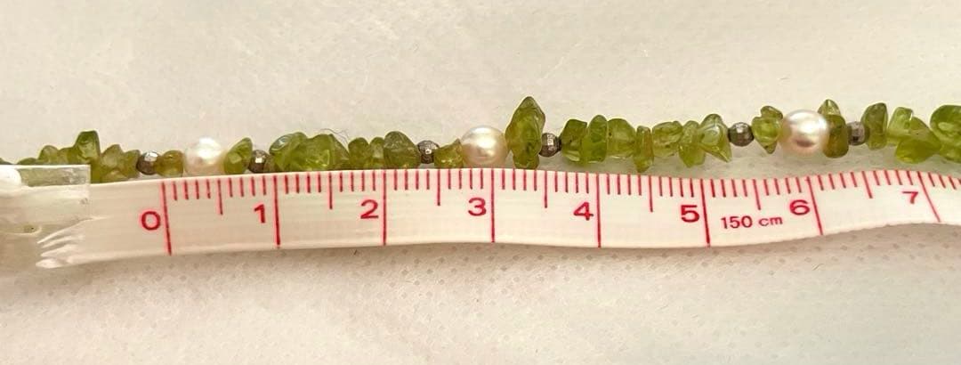 Pink Aurora Akoya Pearl necklace featuring 7 baby pearls and peridot stones with silver clasp