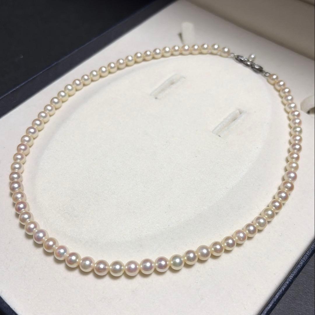 Mikimoto Akoya Pearl Necklace with 5.5mm baby pearls and high luster on a white background