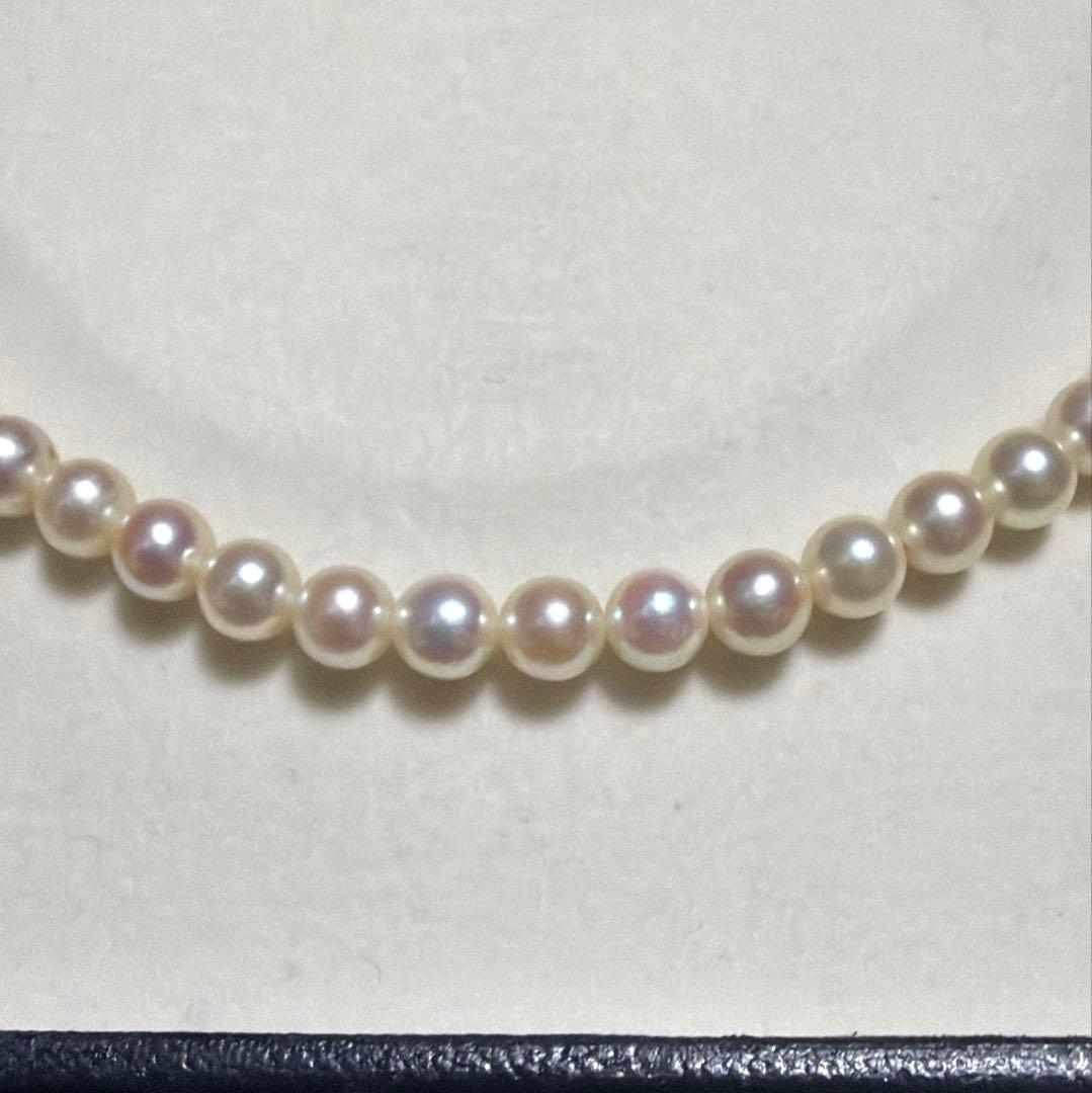 Mikimoto Akoya Pearl Necklace with 5.5mm baby pearls and high luster on a white background