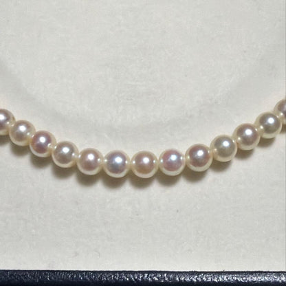 Mikimoto Akoya Pearl Necklace with 5.5mm baby pearls and high luster on a white background
