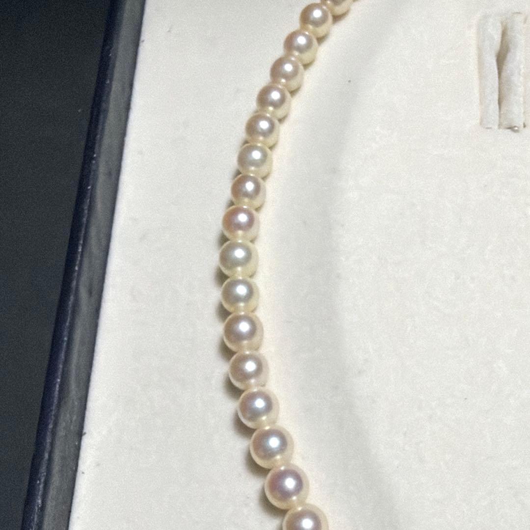 Mikimoto Akoya Pearl Necklace with 5.5mm baby pearls and high luster on a white background