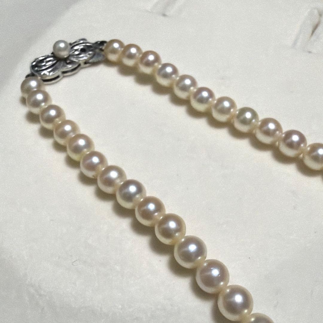 Mikimoto Akoya Pearl Necklace with 5.5mm baby pearls and high luster on a white background