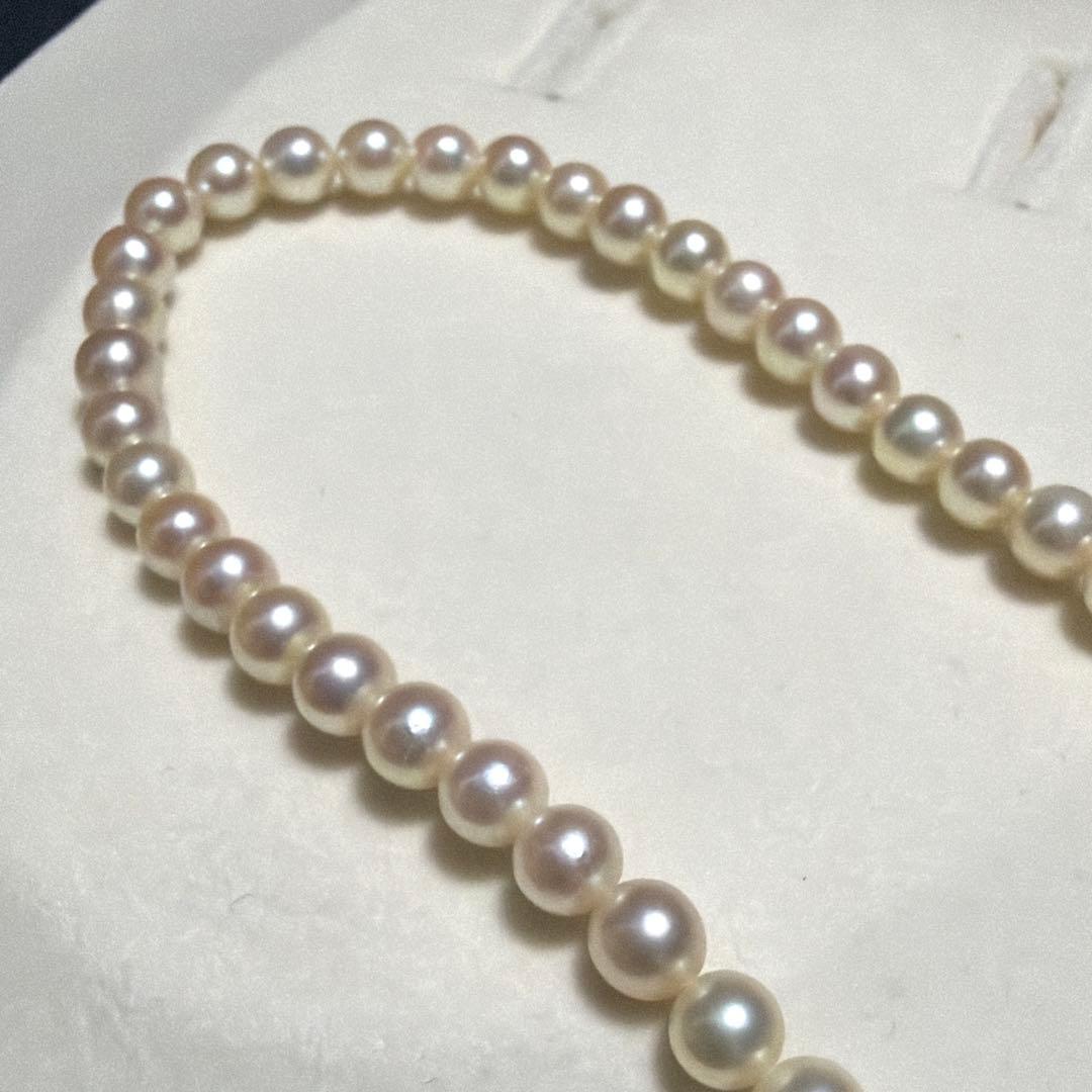Mikimoto Akoya Pearl Necklace with 5.5mm baby pearls and high luster on a white background
