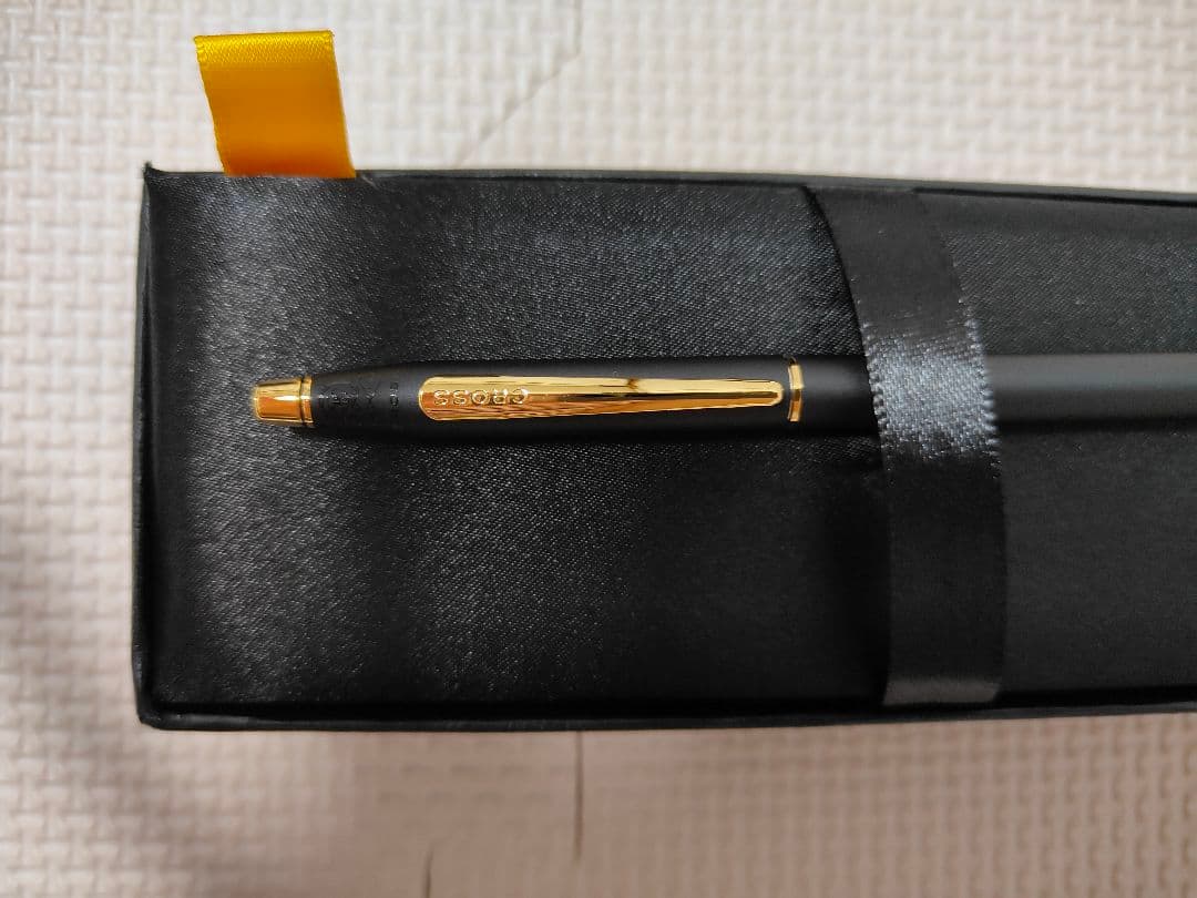 Cross black ballpoint pen with gold fittings shown on white background