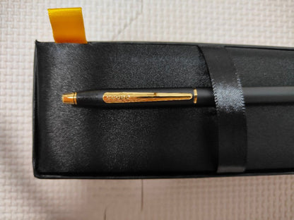 Cross black ballpoint pen with gold fittings shown on white background