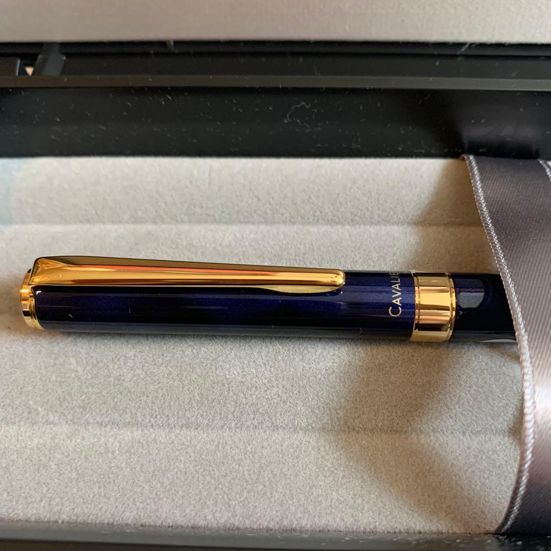 Pilot Cavalier Fountain Pen in dark blue with silver trim shown uncapped on white background