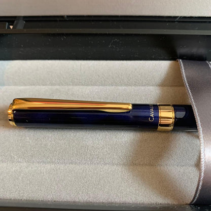 Pilot Cavalier Fountain Pen in dark blue with silver trim shown uncapped on white background