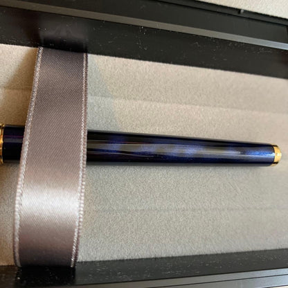 Pilot Cavalier Fountain Pen in dark blue with silver trim shown uncapped on white background