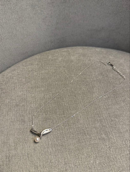 Tasaki silver necklace with a thin chain featuring a soft pearl and simple sophisticated design