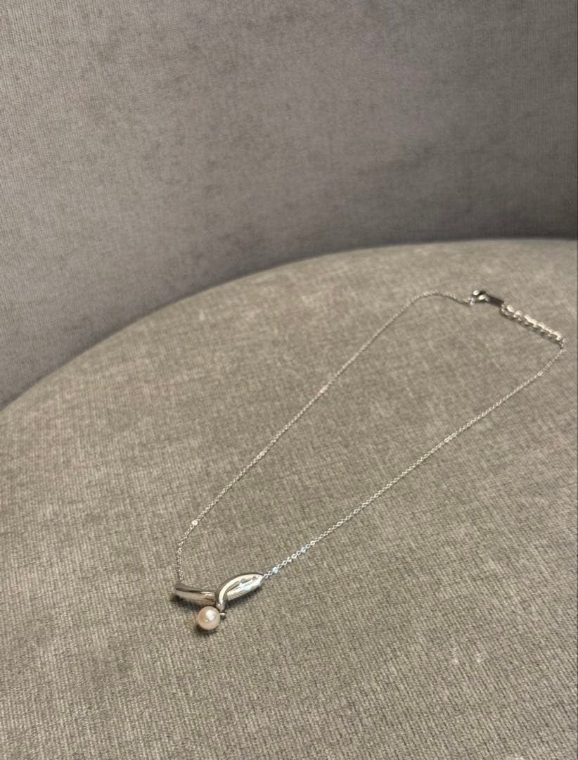 Tasaki silver necklace with a thin chain featuring a soft pearl and simple sophisticated design
