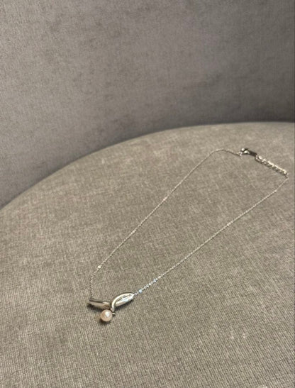 Tasaki silver necklace with a thin chain featuring a soft pearl and simple sophisticated design