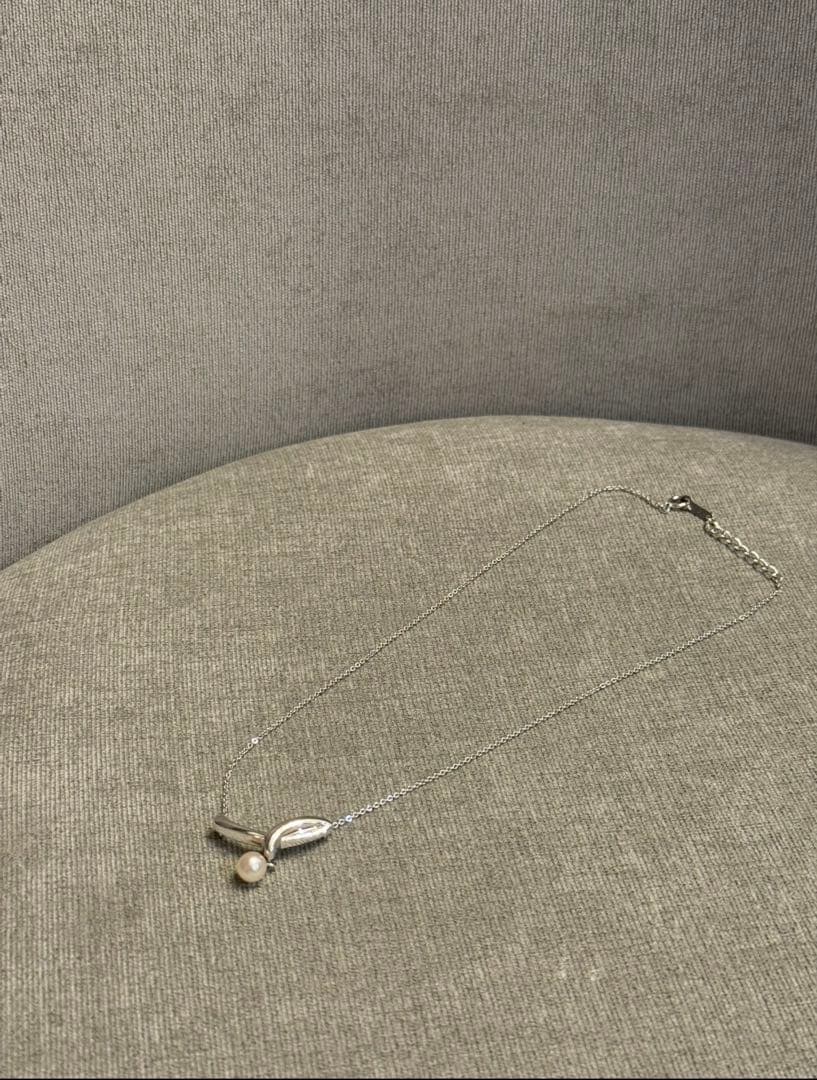 Tasaki silver necklace with a thin chain featuring a soft pearl and simple sophisticated design