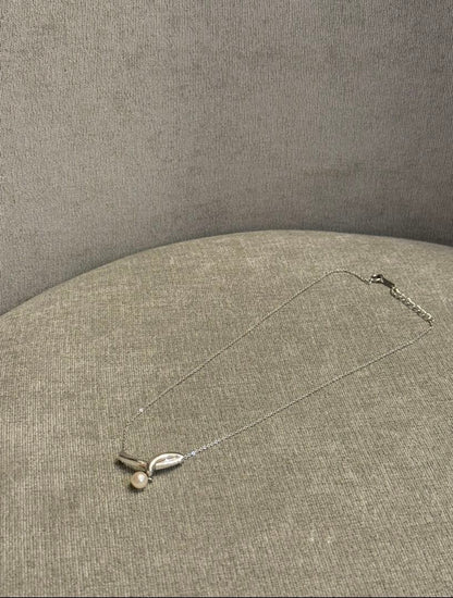 Tasaki silver necklace with a thin chain featuring a soft pearl and simple sophisticated design