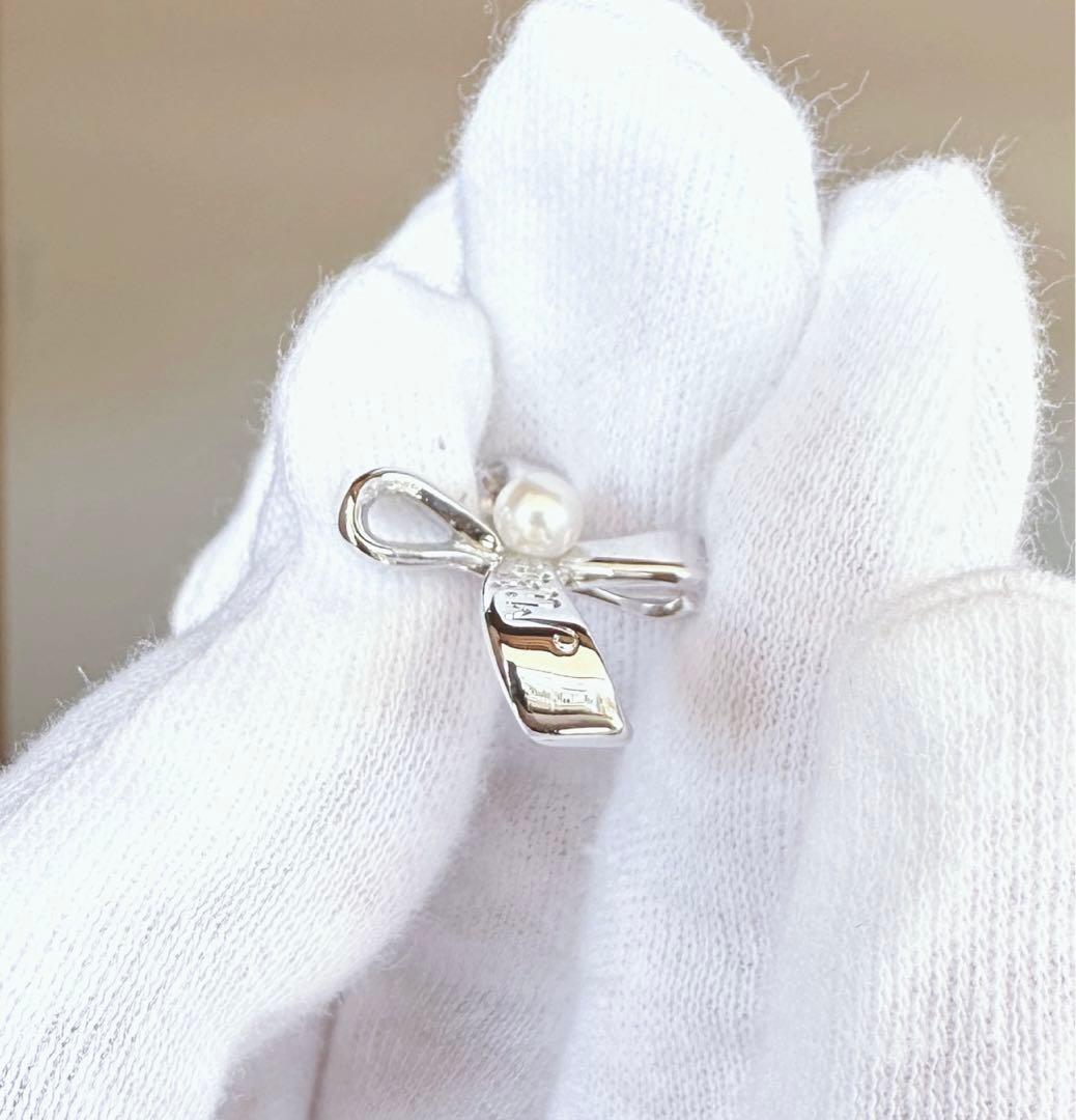 MIKIMOTO silver cross pendant top with 4.5mm Akoya pearl on a white background