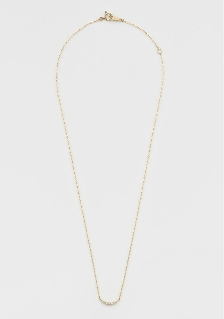Nika K10 gold necklace with diamond pendant and spring ring clasp on a white background