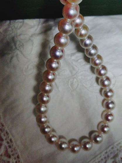Akoya pearl necklace featuring large 8.5-9mm pink tone pearls with good luster displayed with Mitsukoshi case