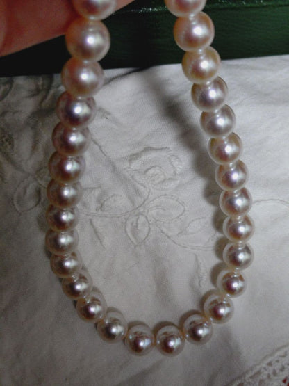 Akoya pearl necklace featuring large 8.5-9mm pink tone pearls with good luster displayed with Mitsukoshi case