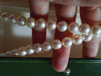 Akoya pearl necklace featuring large 8.5-9mm pink tone pearls with good luster displayed with Mitsukoshi case