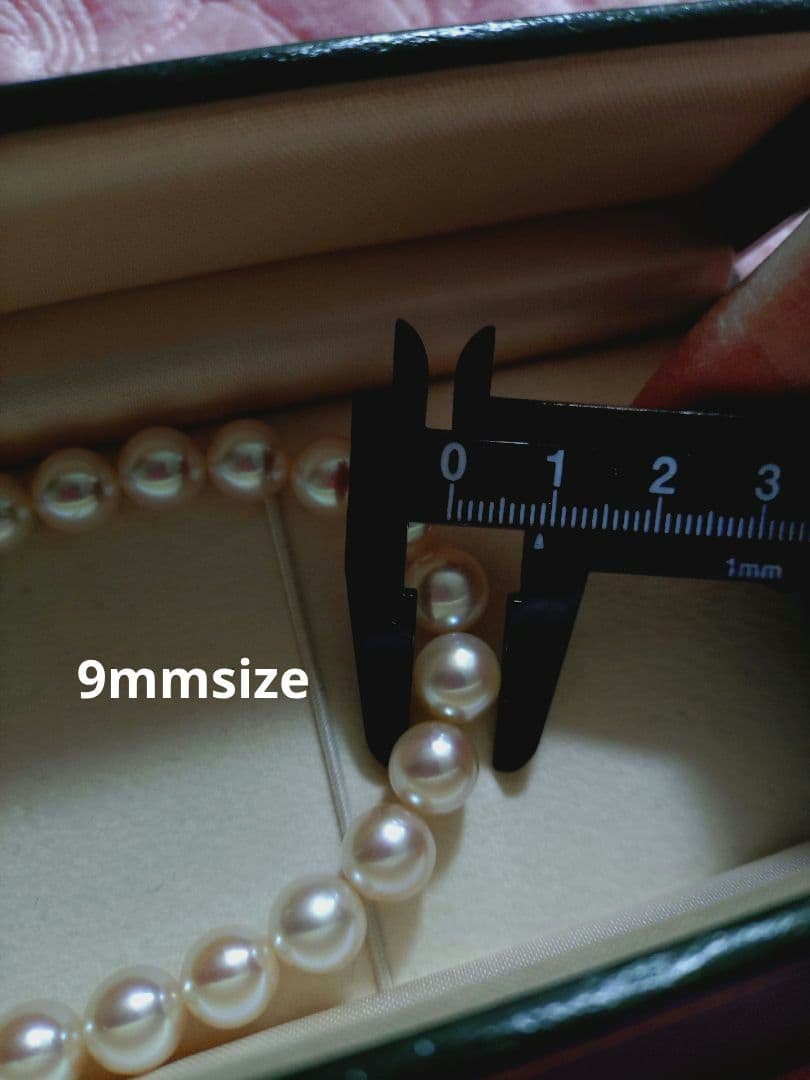 Akoya pearl necklace featuring large 8.5-9mm pink tone pearls with good luster displayed with Mitsukoshi case