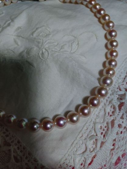 Akoya pearl necklace featuring large 8.5-9mm pink tone pearls with good luster displayed with Mitsukoshi case