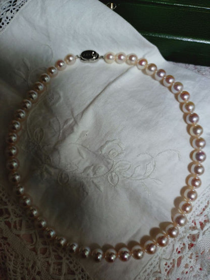 Akoya pearl necklace featuring large 8.5-9mm pink tone pearls with good luster displayed with Mitsukoshi case