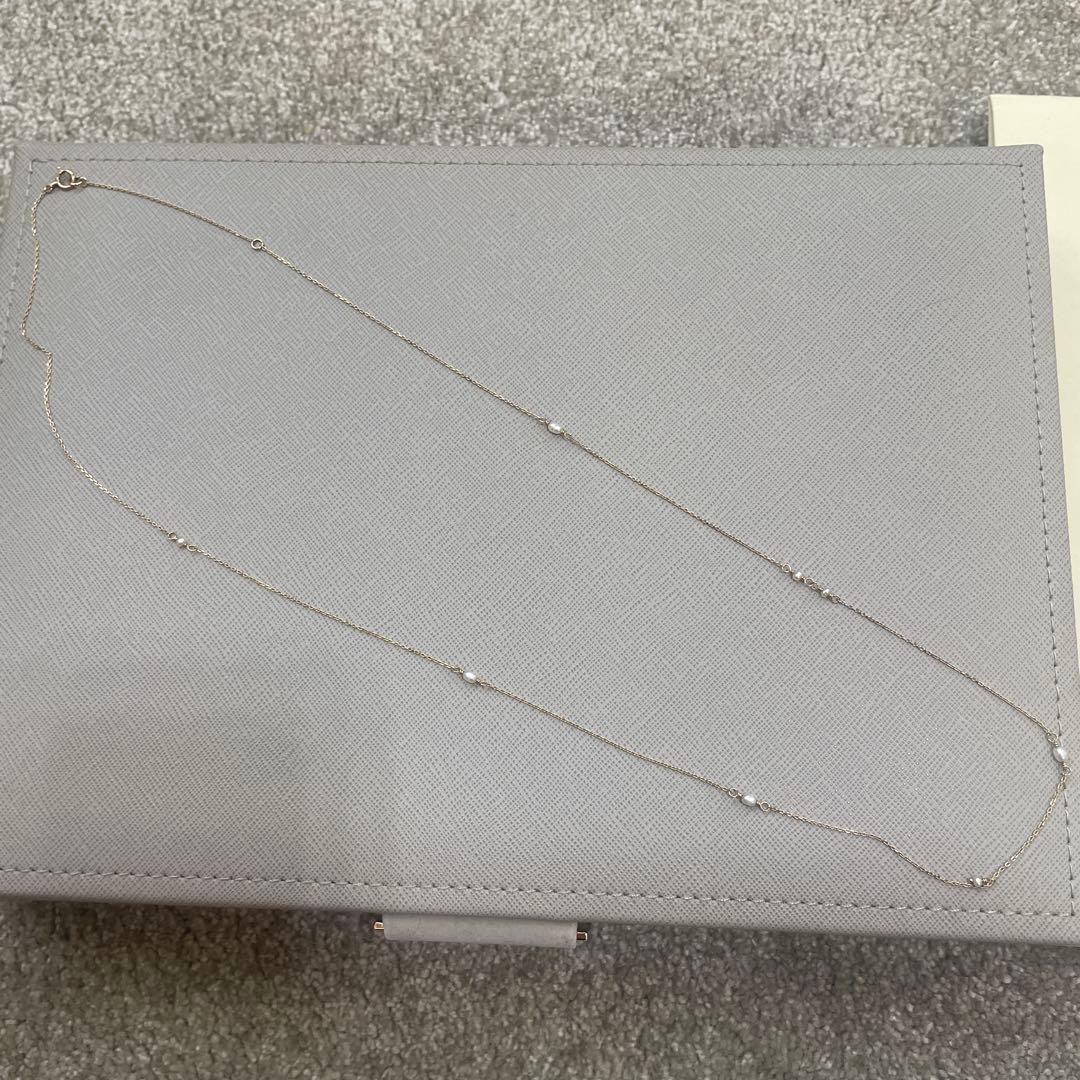 Acat Freshwater Pearl Necklace 60cm length with white pearls and simple clasp on a white background
