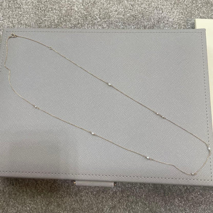 Acat Freshwater Pearl Necklace 60cm length with white pearls and simple clasp on a white background