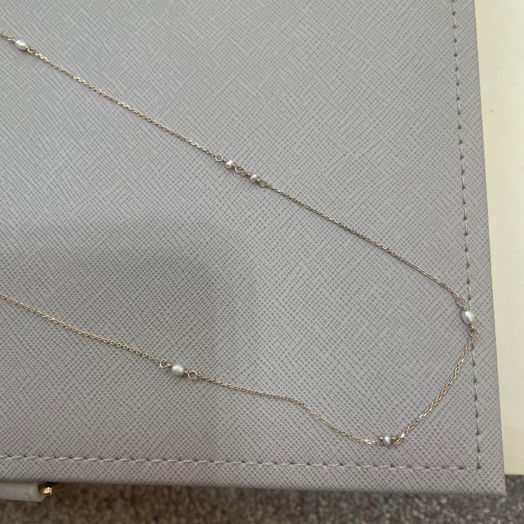 Acat Freshwater Pearl Necklace 60cm length with white pearls and simple clasp on a white background