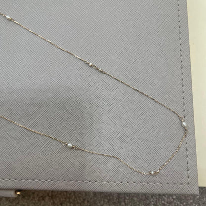 Acat Freshwater Pearl Necklace 60cm length with white pearls and simple clasp on a white background